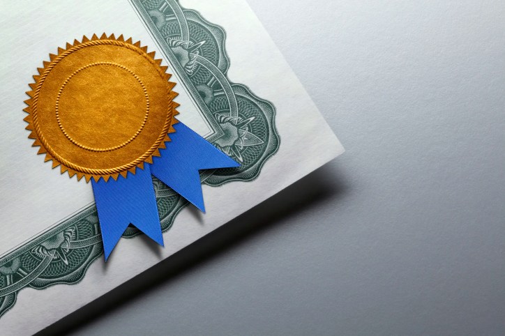 Gold seal with a blue ribbon on certificate.