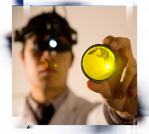 An ophthalmologist giving an eye exam through the help of ophthalmology standards.