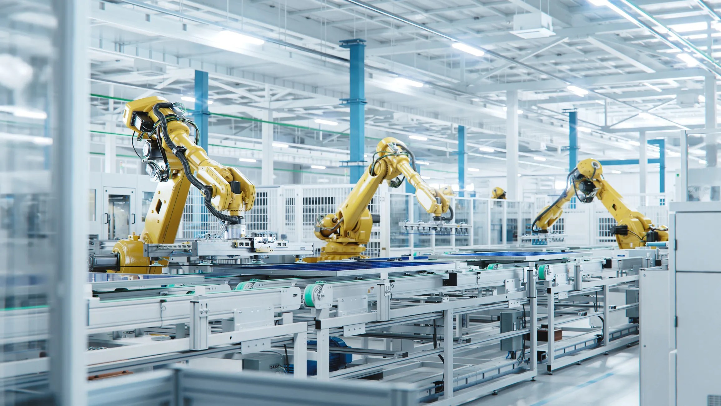 Three yellow arms working in automation at factory.