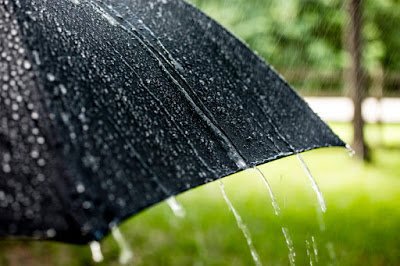 Black umbrella on a rainy day that would have followed ASTM D4112-02.
