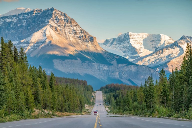 Single EV moving on road in Canadian Rockies Icefields Parkway Jasper National Park