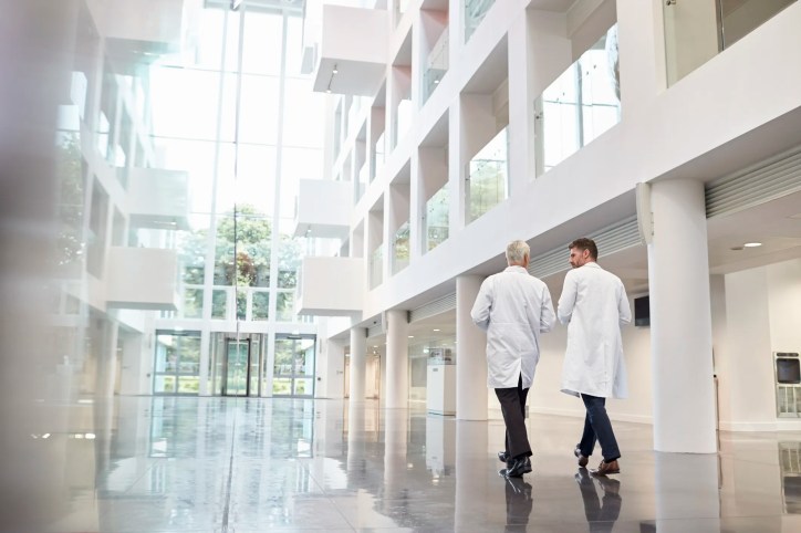 Doctors walking through clean and advanced health care facility.
