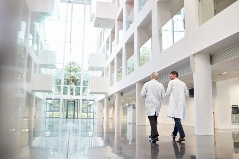 Doctors walking through clean and advanced health care facility.