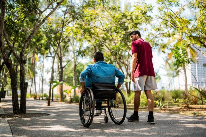 Wheelchair moving through public park