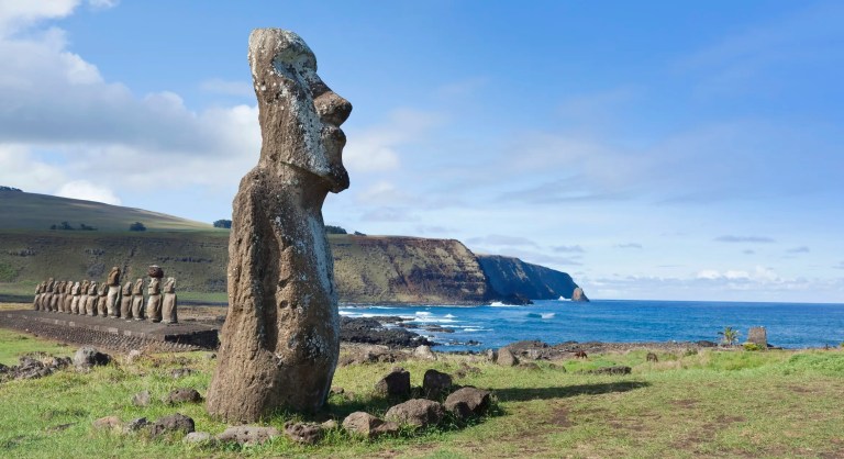 Easter Island head facing the sea under blue sky