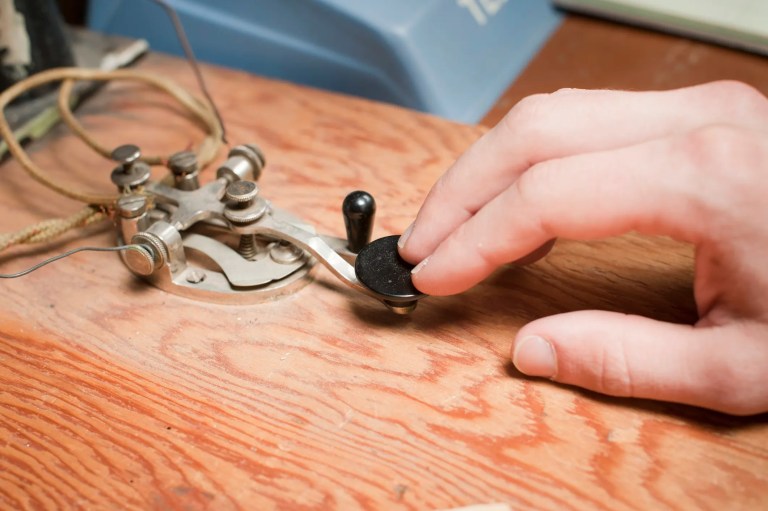 Telegraph key being used on wood