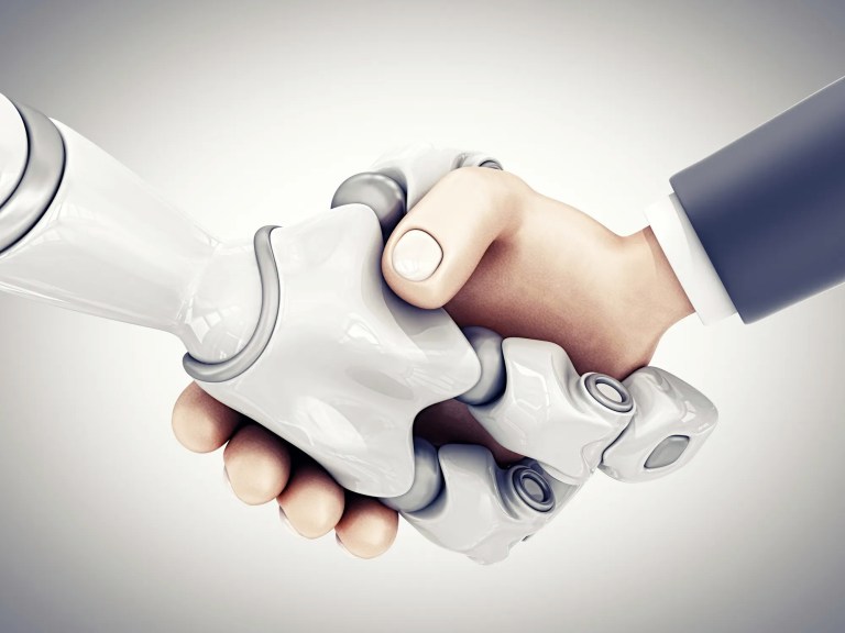 Businessman shaking hand with robot hand in collaboration