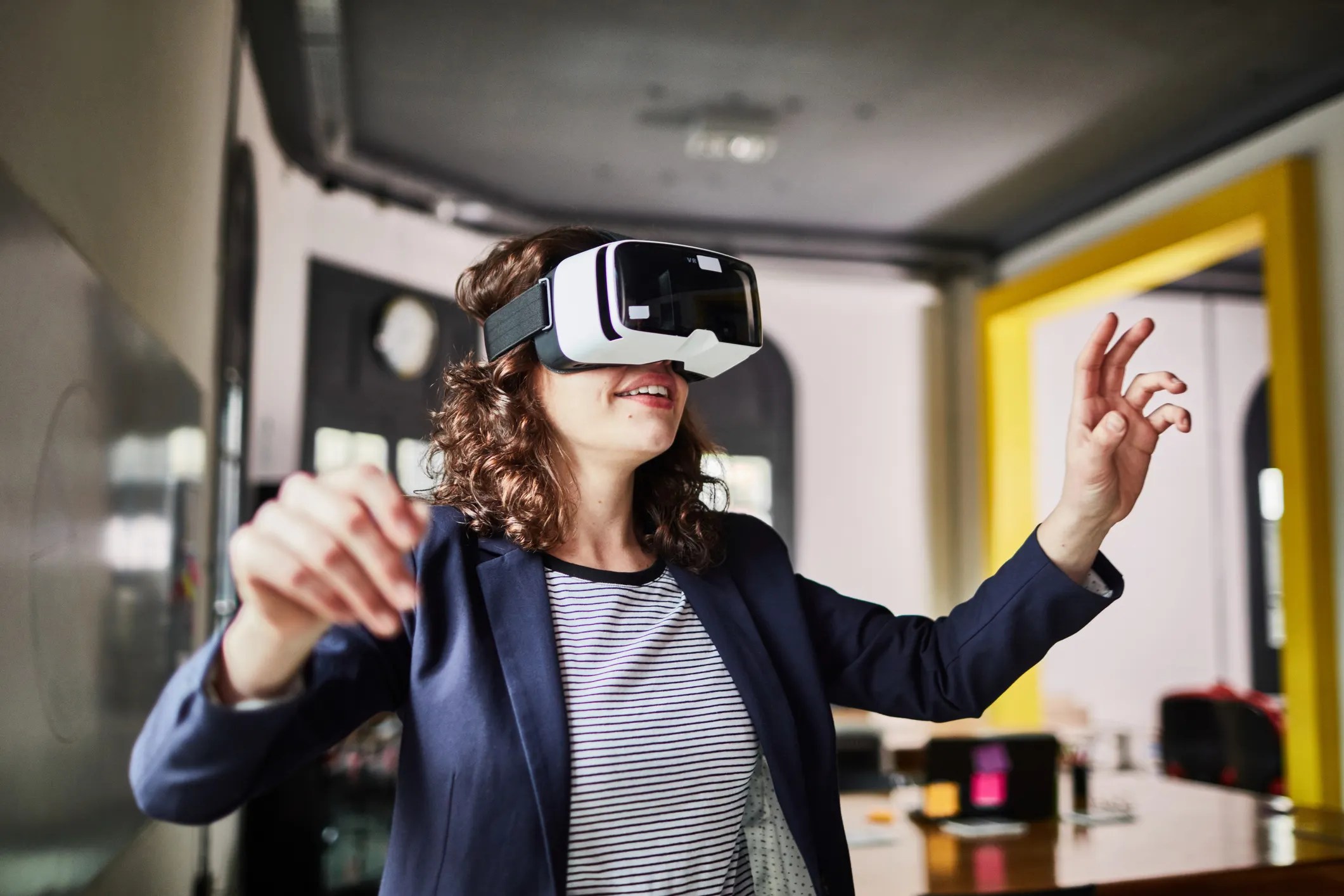 Woman wearing VR headset near her yellow wall