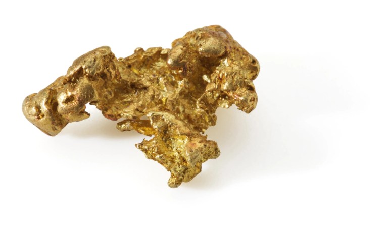 Gold nugget on white background that could be used in titanium-gold alloy