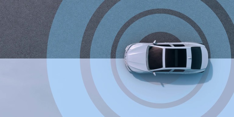 Self driving car moving on road with blue circles detecting nearby traffic