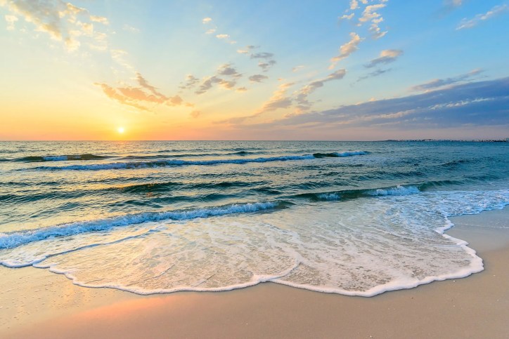 Beach wave foam rolling onto sand in Tunisian coast