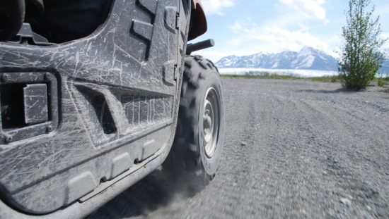 An ANSI/OPEI B71.9 multipurpose off-highway utility vehicle cruising safely in the dirt.