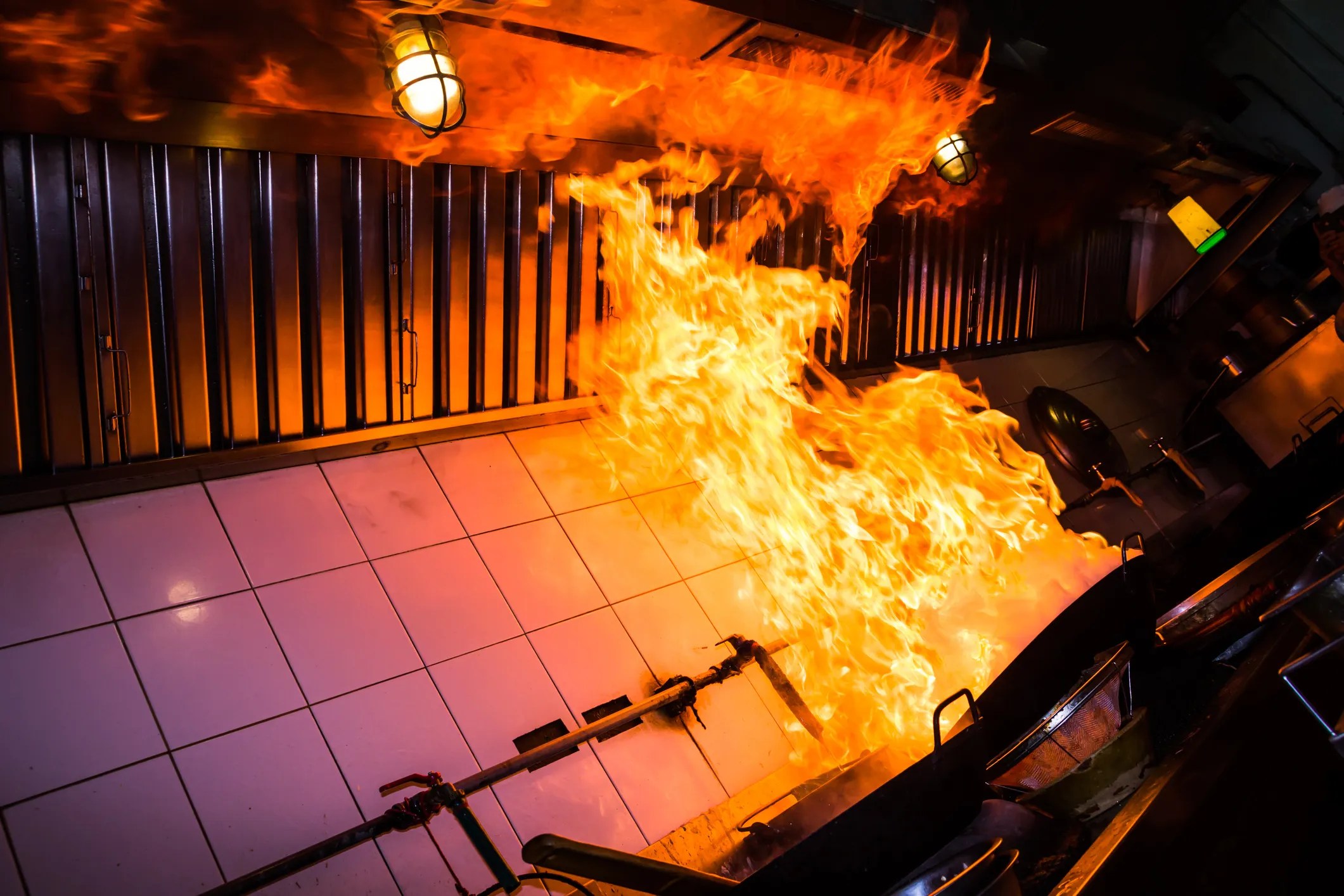 Flames erupting on restaurant stove to contain fire with ANSI Z83.11.
