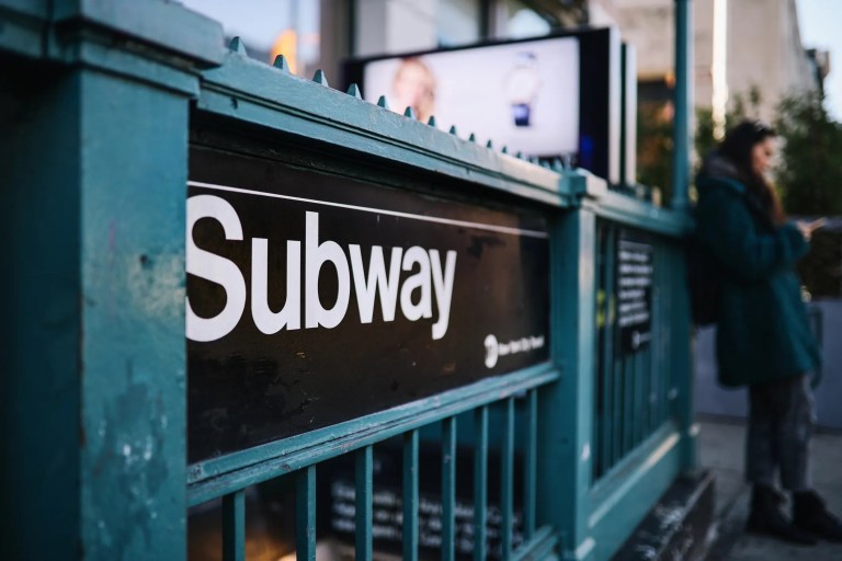 NYC subway green rails on entrance stairs