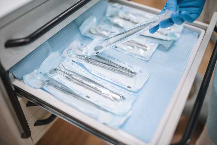 Surgical Equipment Sterilized dental tools wrapped in cabinet after undergoing ethylene oxide contract sterilization.