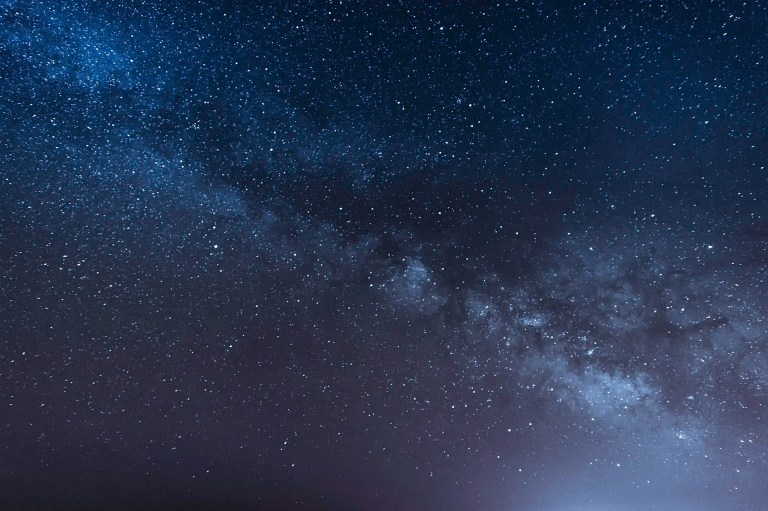 Purple and black Milky Way Galaxy crack through space