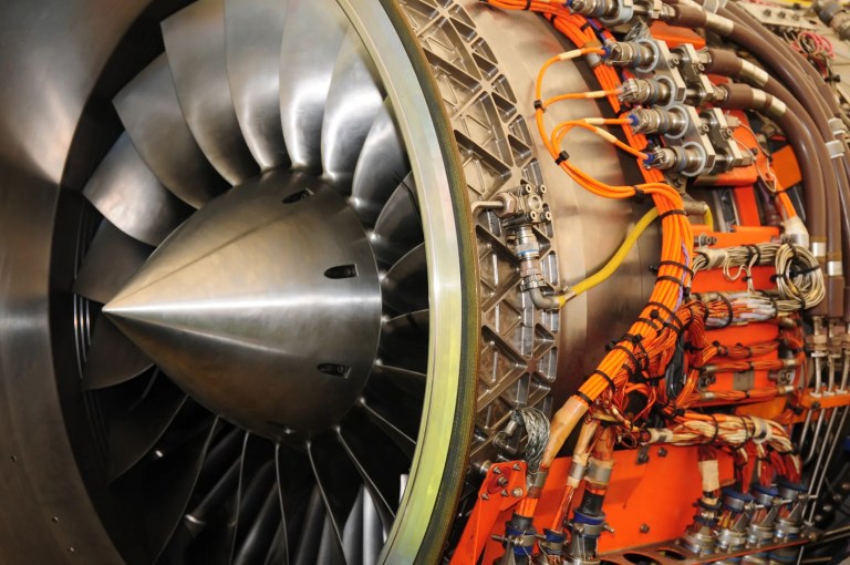 Jet engine showing visible orange tubes and wire during process management check