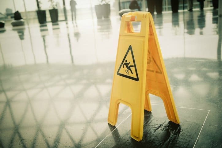 A wet surface sign put in a hotel lobby to follow ANSI ASSE A1264.1