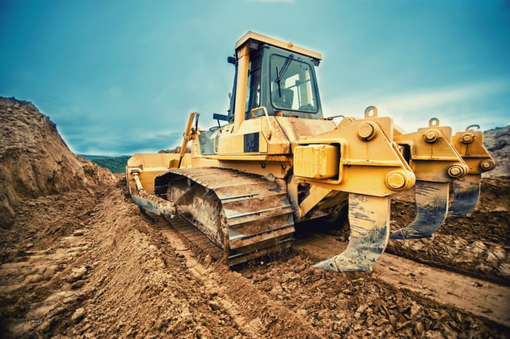 Construction equipment on a construction site complying with SAE J 1455-2017