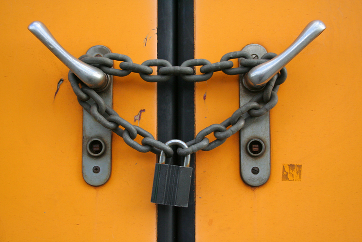 Door handles with a chain link around them and a lock on connecting the ends