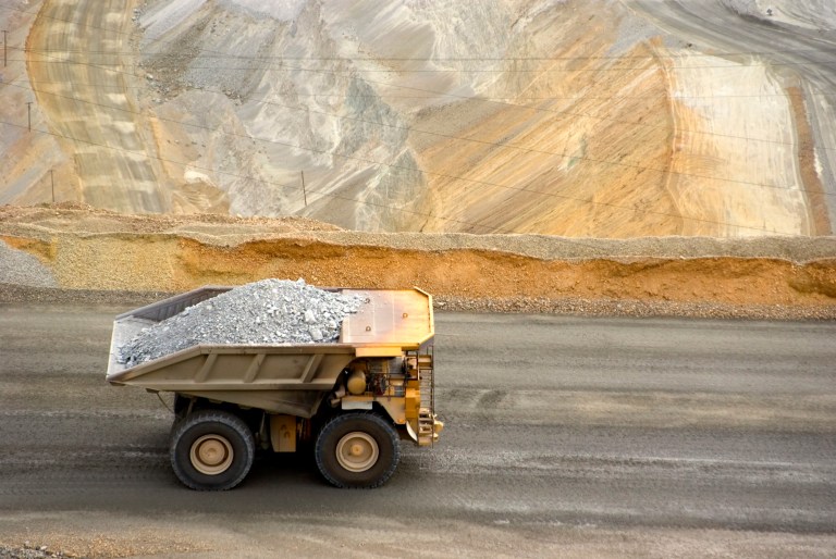 Full dump truck driving through Utah with SAE J1455 electrical equipment