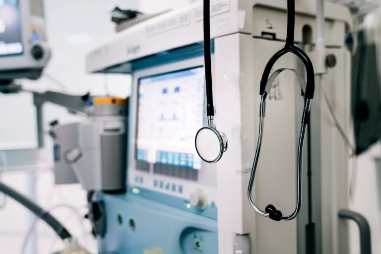 Stethoscope hanging on white sterilized medical ventilator