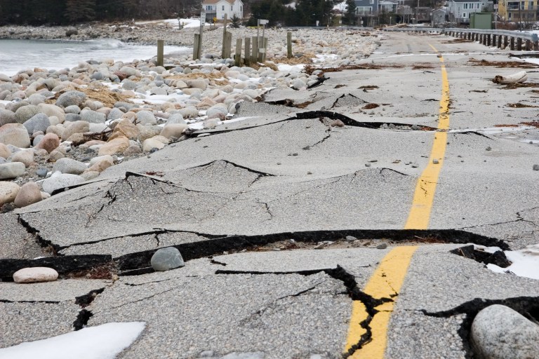 Wrecked beach road all cracked up in its asphalt yellow line in need of ASCE/SEI 4 seismic analysis