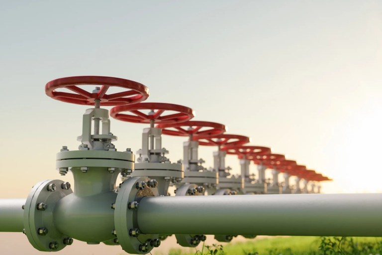 Red oil valves lined up outside on piping to properly follow ANSI/MSS SP-96 terminology