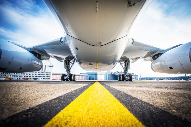 Aircraft fuselage above runway that may follow SAE AMS 2249H for titanium