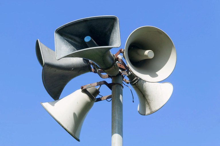 Public address system before blue sky with five Infocomm horns