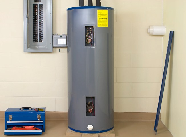 A gray residential water heater under ANSI Z21.10/CSA 4 repairs.