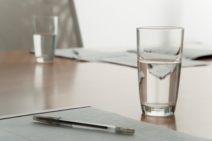 A glass half full of water resulting from NSF/ANSI standards from the treatment of their components.