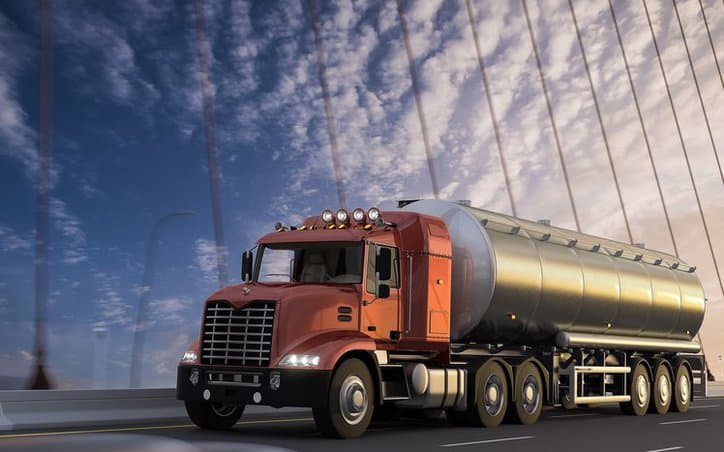 A new truck crossing a suspension bridge to deliver cryogenic liquids in accordance with CGA 341-2017.