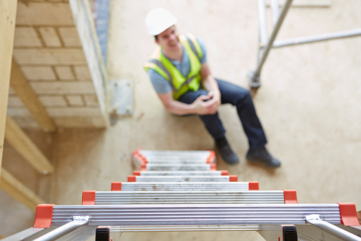 Man who aches in pain due to falling prey to overreaching, one of the common causes of ladder accidents