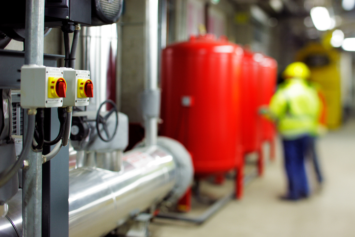 Large red canisters used for industrial heating oil under ASTM D396