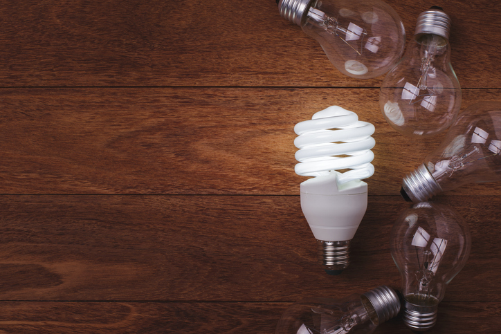 LED lightbulb shining brightly by following the ASTM E2659-18 Certificate Program Standard for accreditation and training.