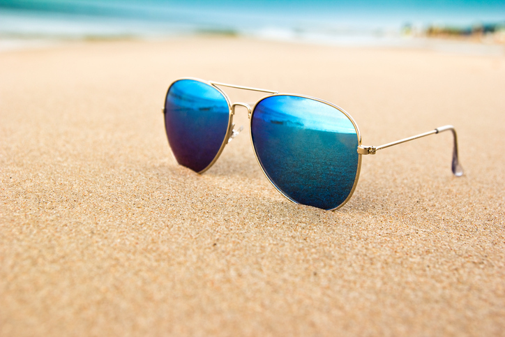 A cool pair of ANSI Z80.3:2018 sunglasses on the beach