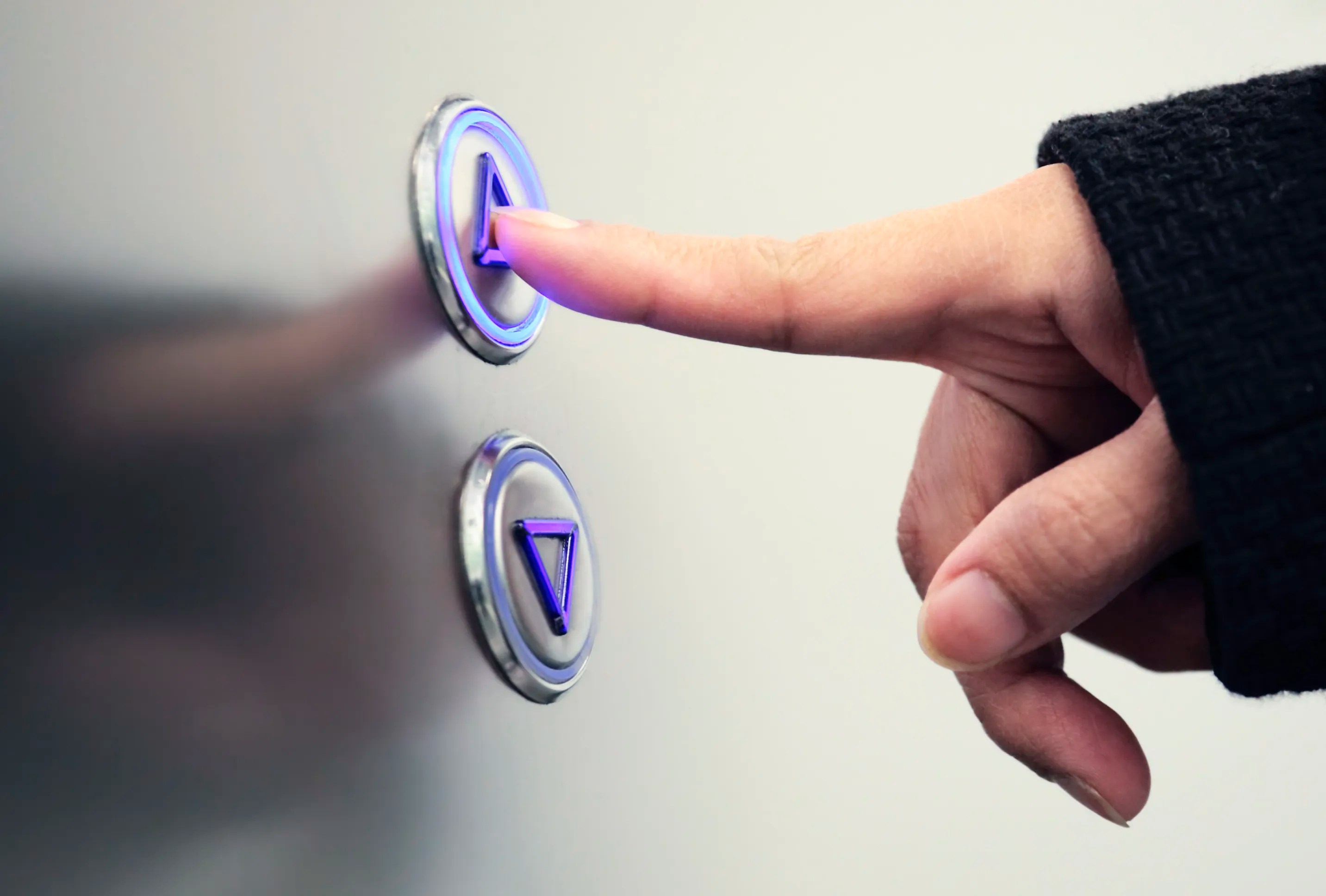 Pushing an elevator button up in accordance with ASME A17.1, or CSA B44, a binational standard.