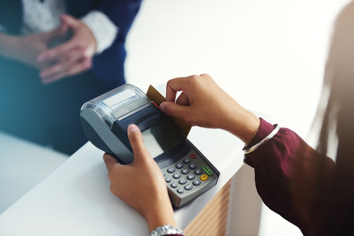 Swiping a credit car and completing the purchase via ASC X9 TR 31-2018 interoperable key technology.
