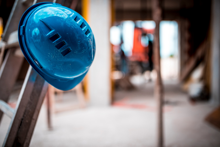 Guy who hangs up his blue hardhat on ladder could use some serious construction safety tips.