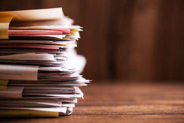 Stack of folders to show the ASTM standards that have been withdrawn.