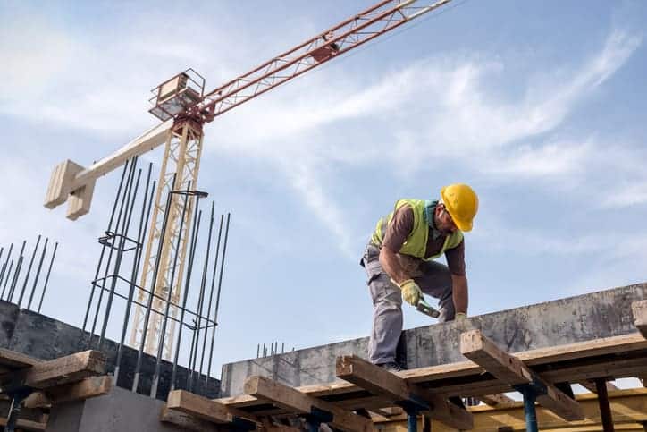 Man works hard in construction site to follow ASSE, now ASSP, standards.