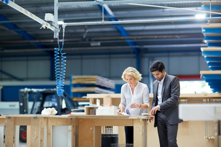 Man and woman revising quality plan to ISO 10005:2018