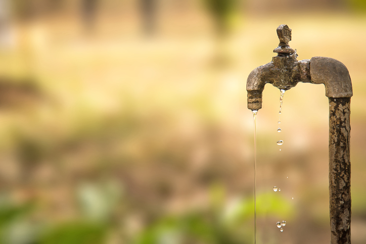 Water dripping from an old pipe, the asbestos in which correlates mesothelioma with drinking water.