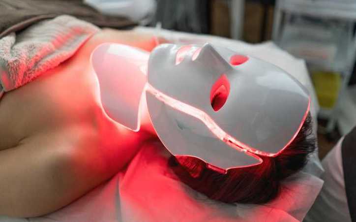 Red laser masks being safely used in spa under ANSI Z136.3-2024 healthcare requirements.