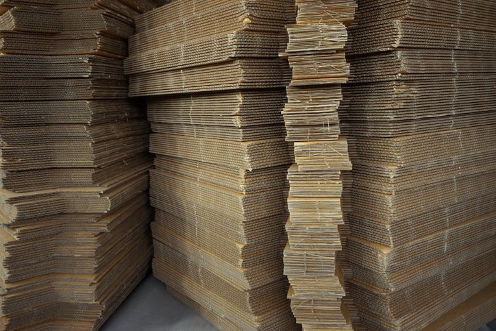 Cardboard boxes stacked after TAPPI T 830-2018 ink rub tests.