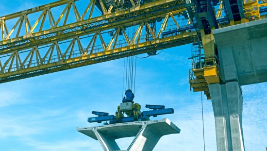 Below the hook lifting devices following ASME B30.20-2018 under yellow tower crane