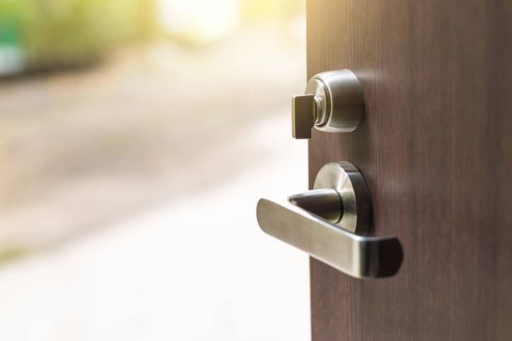 An open door revealing an ANSI/BHMA A156.12-2018 interconnected lock.