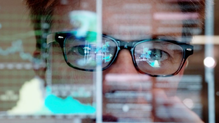 SQL code reflecting in man's glasses and specified in ISO IEC 9075 2016