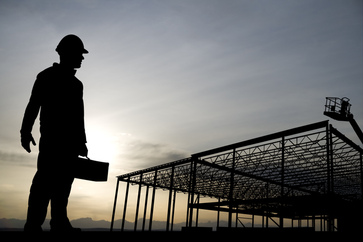 Worker silhouette carrying all ASME B30 safety standards for machine lifting equipment in construction.